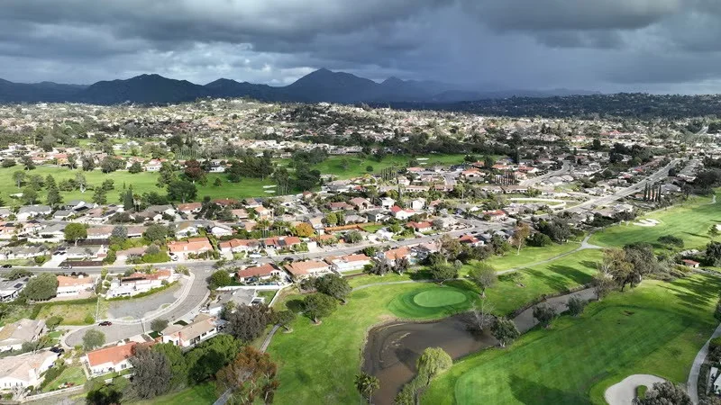 Aerial view of Rancho Bernardo neighborhoods and golf course with mountain backdrop.