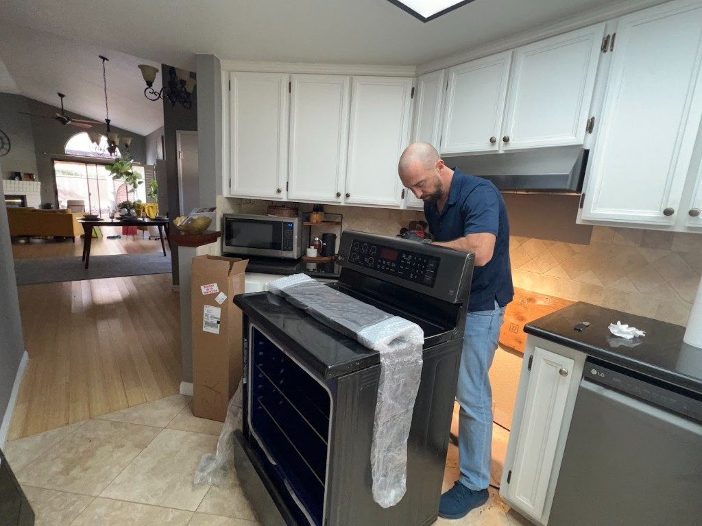 Electric range installation and repair in modern kitchen