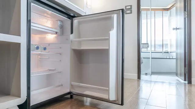 Open compact mini fridge in a modern room interior.