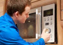 Microwave repair service with professional fixing a broken appliance