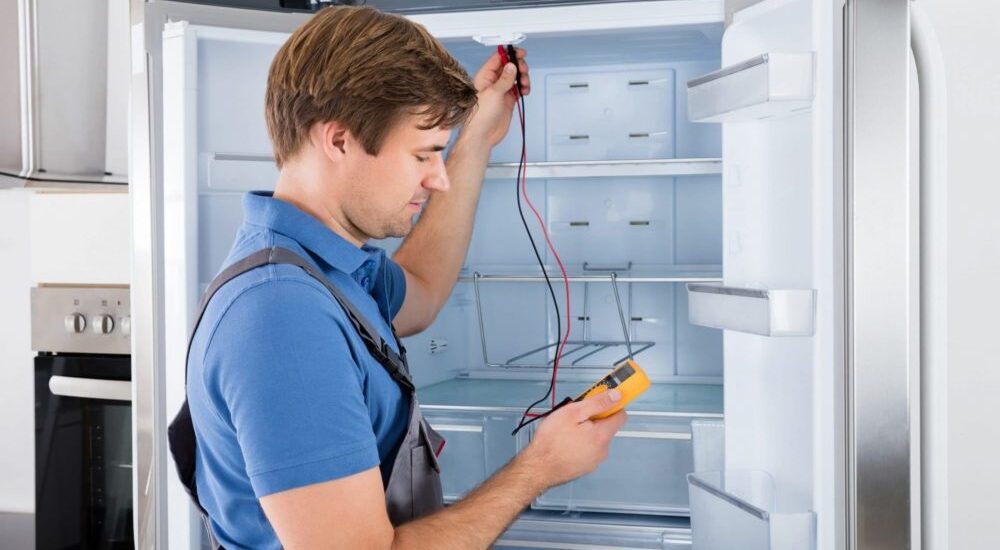 Illustration of a person repairing a refrigerator with tools and parts